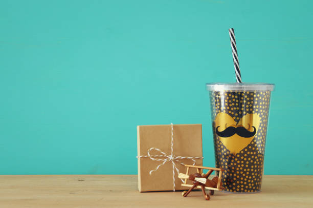 istock Image of black cup with golden heart. Father's day concept. 960932178
