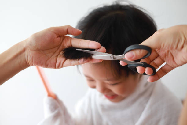 istock Mother giving son haircut 960932478