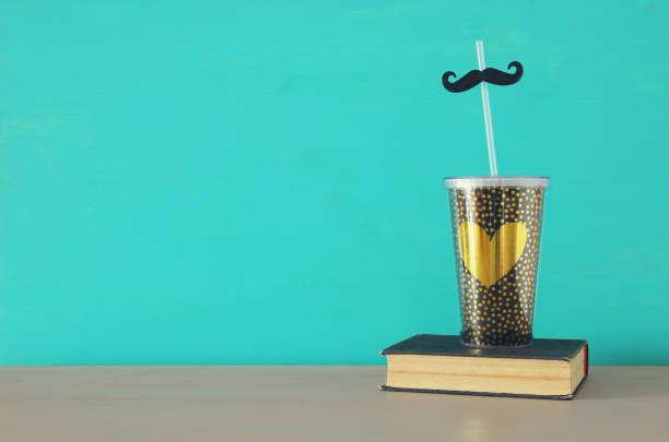 istock Image of plastic cup with golden heart. Father's day concept. 960933534