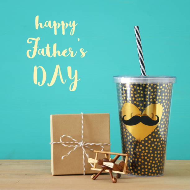 istock Image of black cup with golden heart. Father's day concept. 960933982