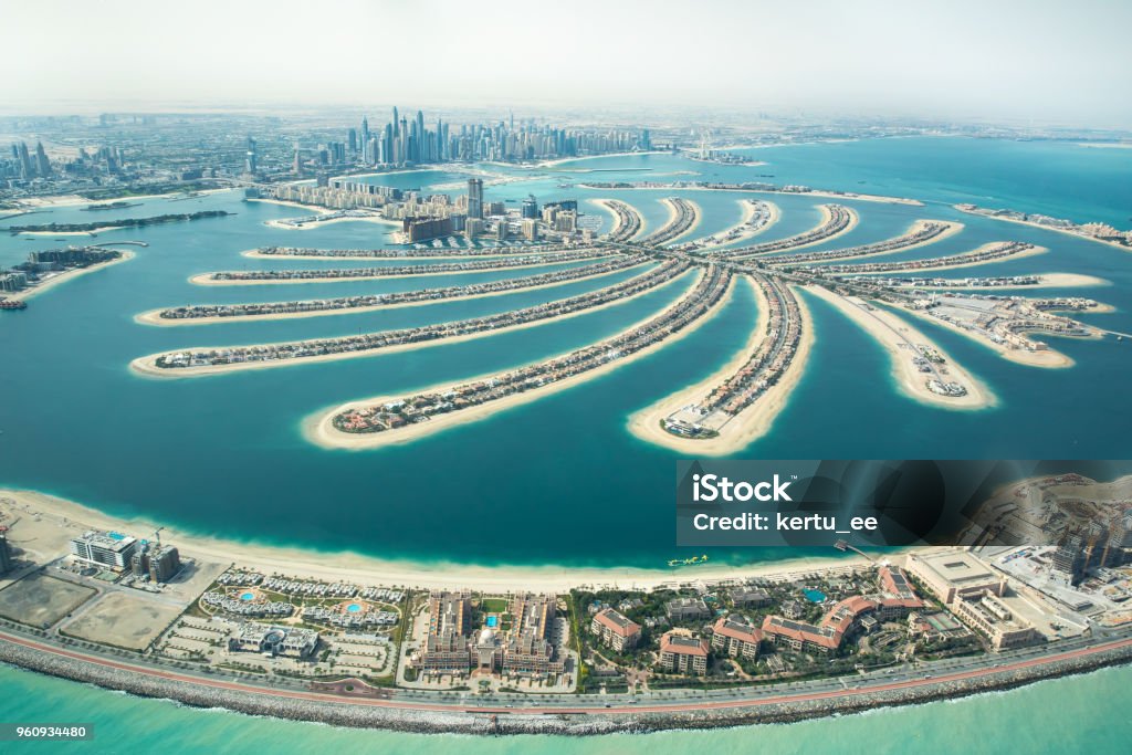 Aerial view of Palm Jumeirah man made island. Aerial view of Palm Jumeirah man made island and Dubai Marina and JBR district on a sunny day. Dubai, UAE. Dubai Stock Photo