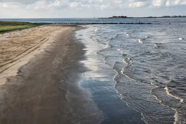 At Grand Isle, Louisiana, the channel entrance to Caminada and Barataria Bays with the ruins of historic Fort Livingston in the background.