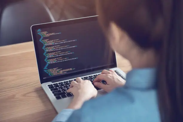 Photo of Woman hands coding html and programming on screen laptop, Web, developer.