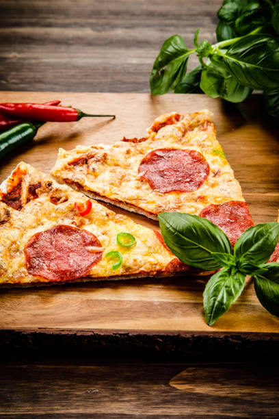 istock Pizza pepperoni on wooden background 960941508