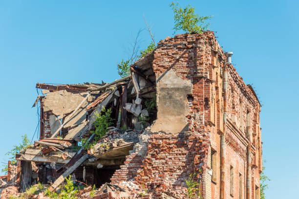 Old destroyed houses of brick with windows, overgrown with plants. Old destroyed houses of brick with windows, overgrown with plants amatrice stock pictures, royalty-free photos & images