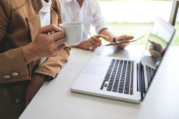 istock Teamwork process, Business team managers colleagues discussing and analysis new project investment plan, strategy in business profit, marketing documents report on table with laptop and tablet 960950604