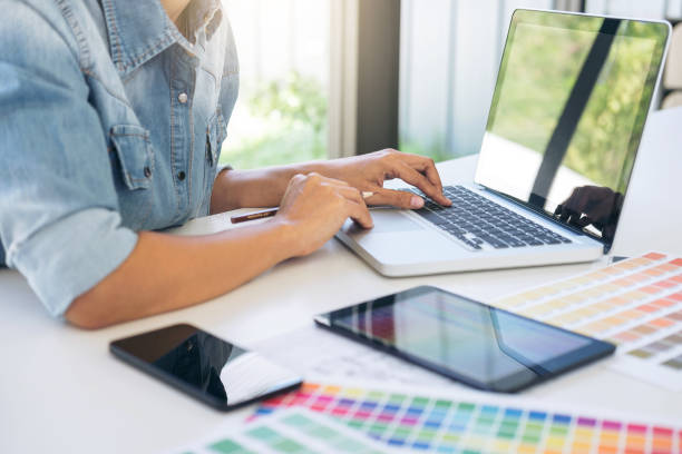 istock Creative creativity graphic designer working with graphics tablet,laptop and smart phone, colour chart at workplace on wooden desk , colour ideas style concept 960950982