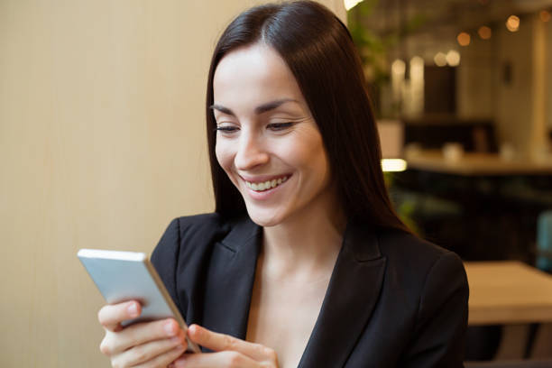 istock Gorgeous smiling woman texting on the phone 960950986