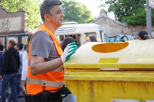 Berlin, Germany - May 19, 2018: Garbage collector at work, outdoors