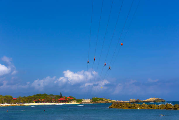 People flying at high zipline on caribbean People flying at high zipline on caribbean at Labadee island at Haiti labadee stock pictures, royalty-free photos & images