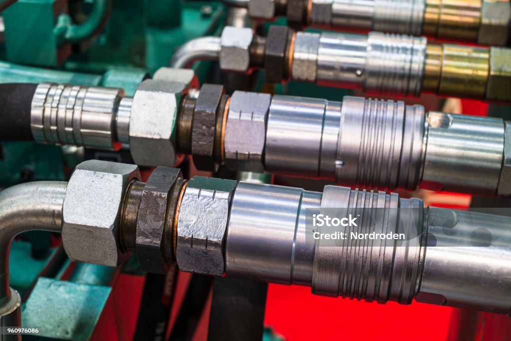 hydraulic coupling connector Several hydraulic coupling connector on a green panel. Hydraulic Platform Stock Photo