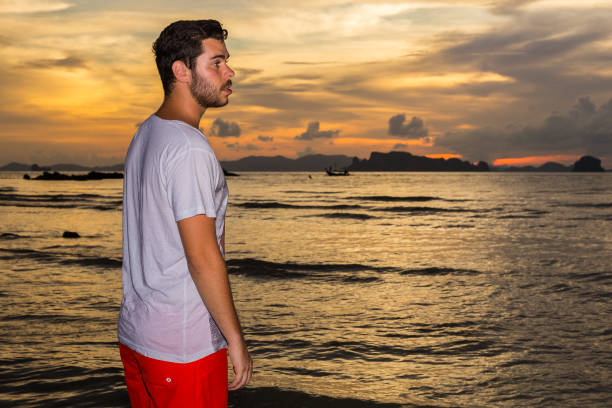 istock Young man posses at Ao Nang Beach, Krabi, Thailand 960976414