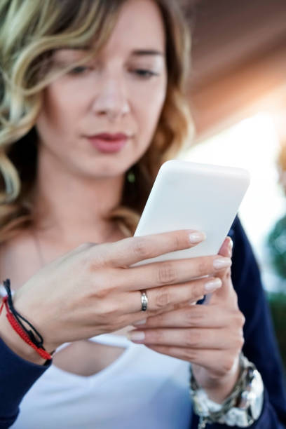 istock Young woman using smart phone in cafe 960984766