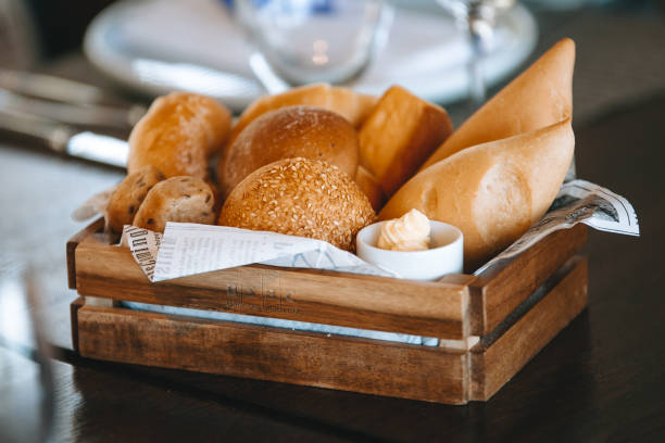 istock buns in a wooden bread box on a table with a white tablecloth in a cozy restaurant before a dinner party 960985448