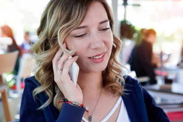istock Young woman using smart phone in cafe 960985758