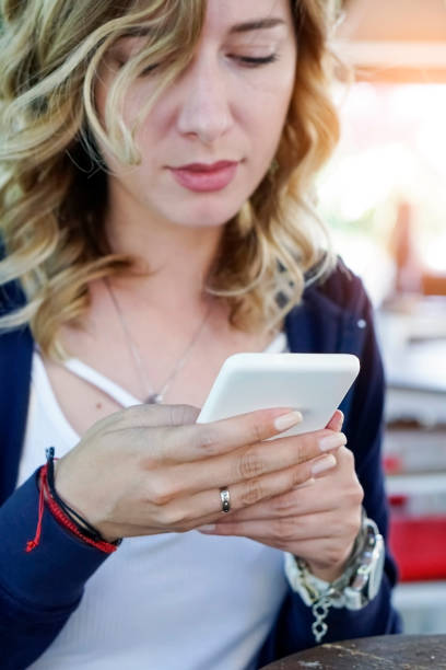 istock Young woman using smart phone in cafe 960986374