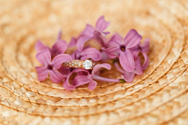 istock jewelry engagement ring with diamonds and spring lilac flowers 960986416