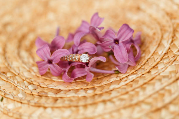 istock jewelry engagement ring with diamonds and spring lilac flowers 960986622