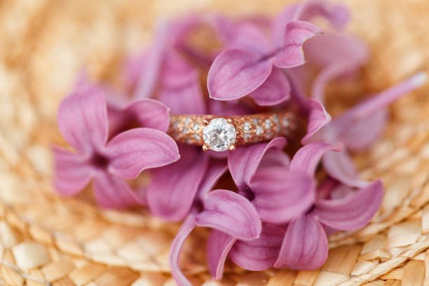 istock jewelry engagement ring with diamonds and spring lilac flowers 960988562