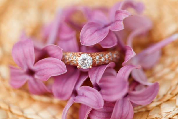 istock jewelry engagement ring with diamonds and spring lilac flowers 960988632