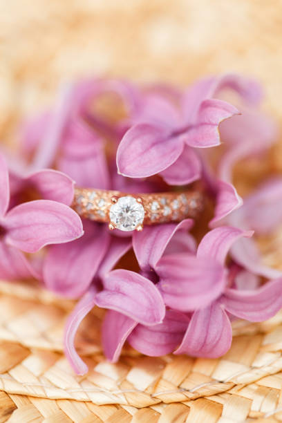 istock jewelry engagement ring with diamonds and spring lilac flowers 960988796