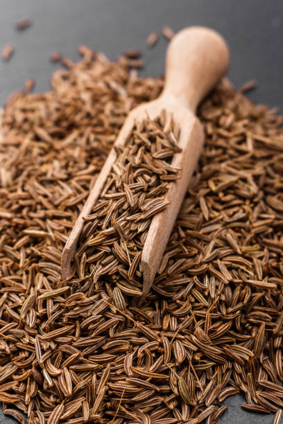 istock Seeds of cumin on a dark stone background 960994948
