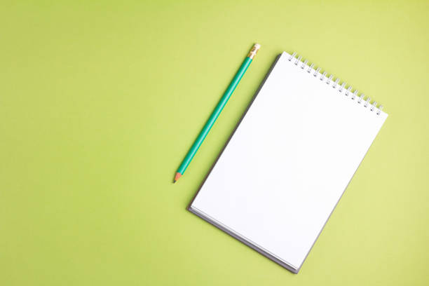 istock Blank notebook with pencil on green pastel background. Flat lay concept. Copy space 961002484
