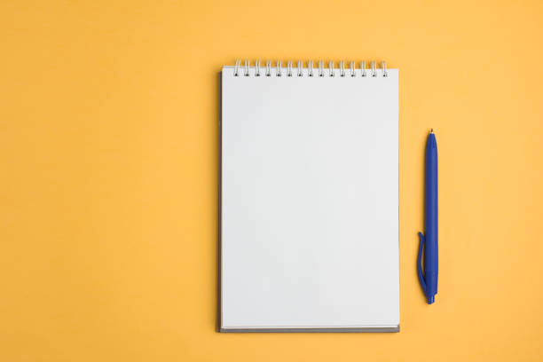 istock Blank notebook with pen on yellow pastel background. Flat lay concept. Copy space 961002606