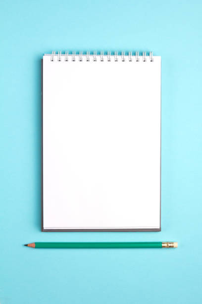 istock Blank notebook with pencil on blue pastel background. Flat lay concept. Vertical view 961002888