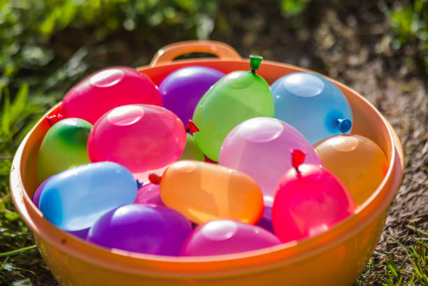 colorful water bombs in summer colorful water bombs in summer ready to play water balloon stock pictures, royalty-free photos & images