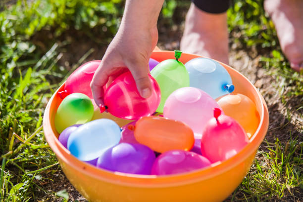 colorful water bombs in summer colorful water bombs in summer ready to play water balloon stock pictures, royalty-free photos & images