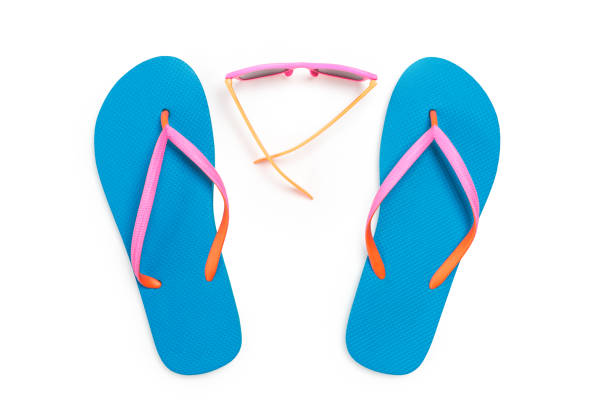 istock Blue Flip Flops and Pink Sunglasses Isolated on White Background. Top view 961006754