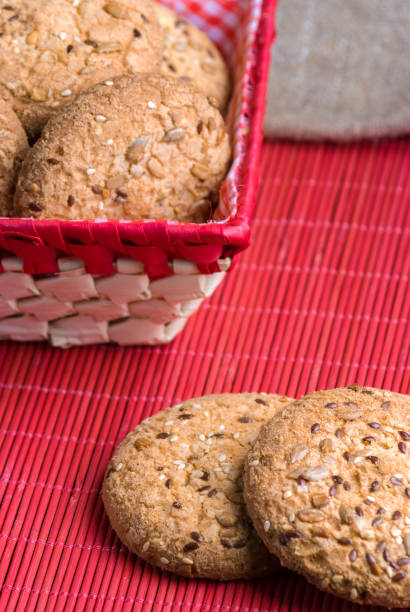 istock Savory cookies sprinkled with sesame seeds, sunflower on table and burlap background 961012480