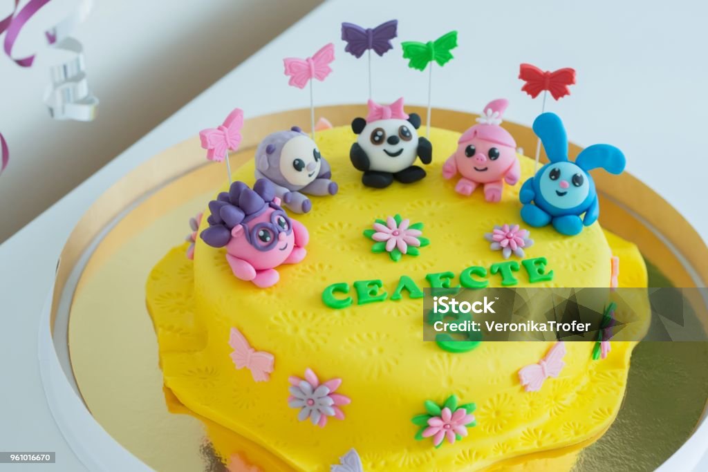 Child Colorful Birthday Cake Decorated With Little Cartoon Characters On  The Top Stock Photo - Download Image Now - iStock