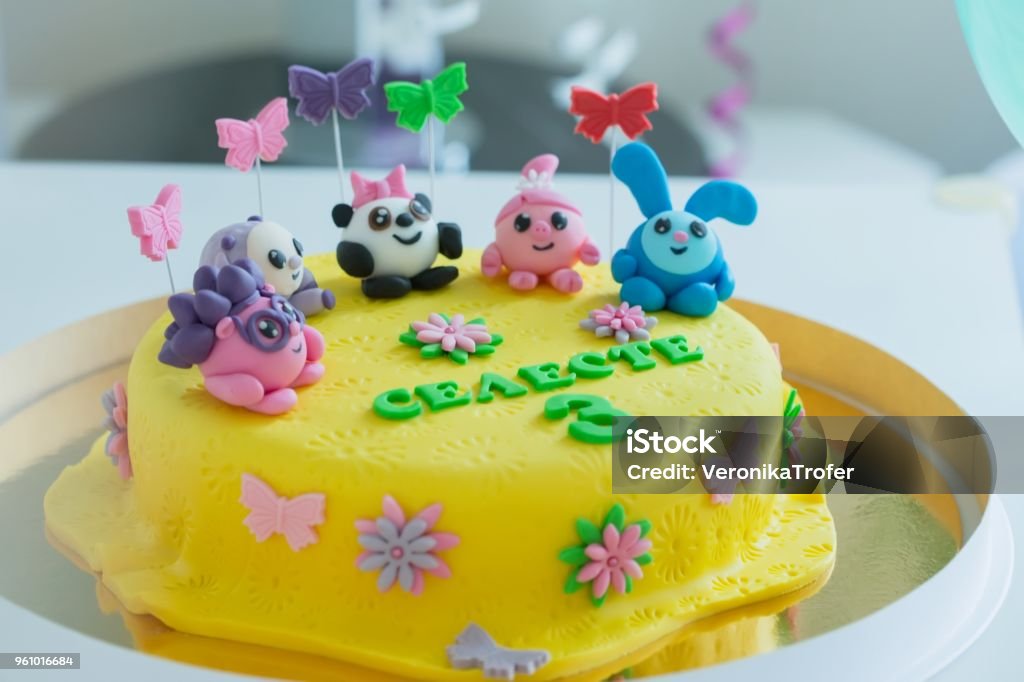 Child Colorful Birthday Cake Decorated With Little Cartoon Characters On  The Top Stock Photo - Download Image Now - iStock