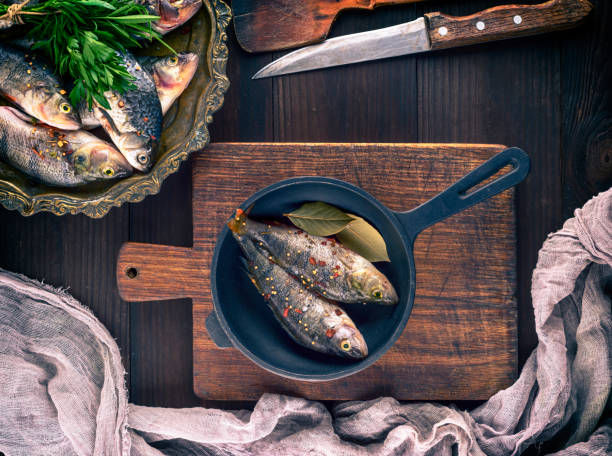 istock fresh fish perch with spices in a black cast-iron frying pan 961025176