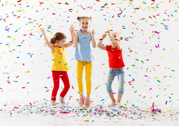 istock happy children on holidays  jumping in multicolored confetti on white 961030882