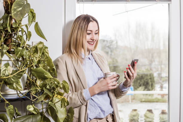 istock Woman in office  chatting by smart phone 961031410