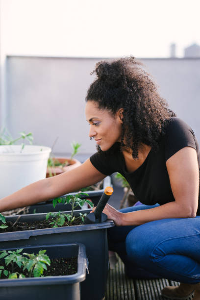 istock Young beautiful woman gardening 961032374