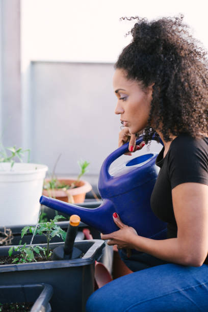 istock Young beautiful woman gardening 961032456
