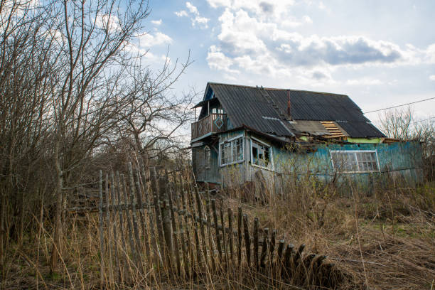 An old rustic wooden ruined house, a fallen fence.
