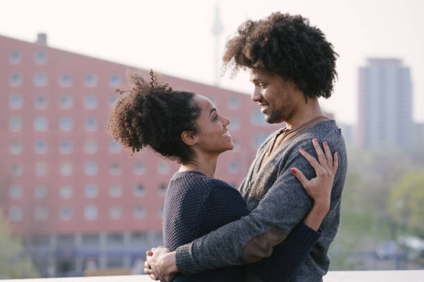 istock Young couple on a rooftop terrace at sunset 961035816