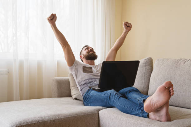 istock Happy bearded man freelancer celebrating victory 961035910