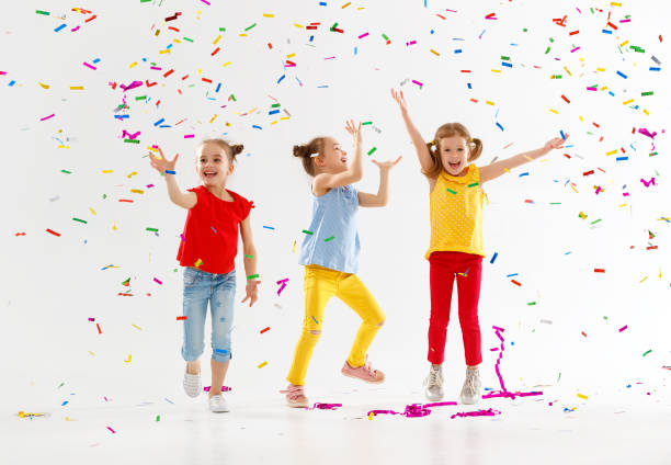 istock happy children on holidays  jumping in multicolored confetti on white 961039188