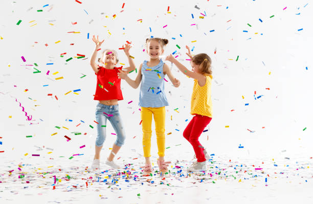 istock happy children on holidays  jumping in multicolored confetti on white 961039346