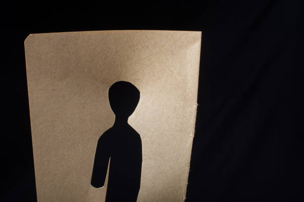 istock Man shape cut out of paper in hand 961047450