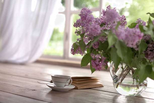 istock Bunch of lilac, books and teacup. 961052496