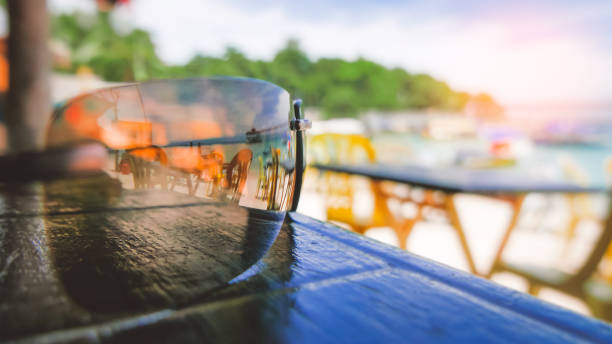 Summertime holidays background, sunglasses on beach bar table stock photo