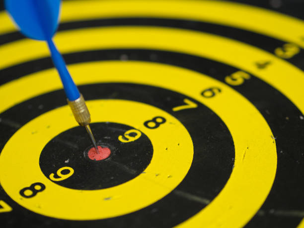 istock black, yellow dartboard and arrow that hits the target 961066156