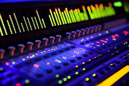 Recording studio, music and musical equipment for broadcast, radio or entertainment industry. Media, instruments and technology for a album or song production and sound track performance in a studio.